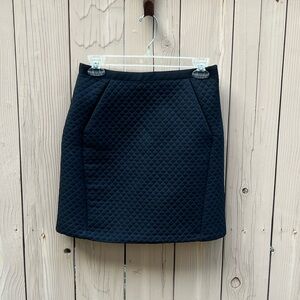 Black quilted mini skirt